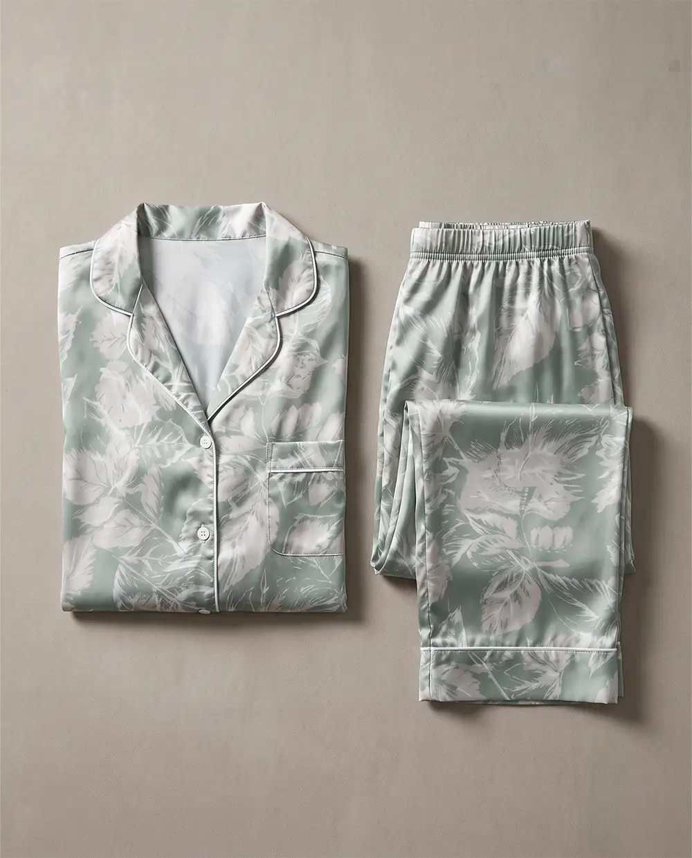 folded-sage-green-satin-pajama-set طقم بيجامة ساتان أخضر فاتح مشجر مطوي بعناية مع البنطلون